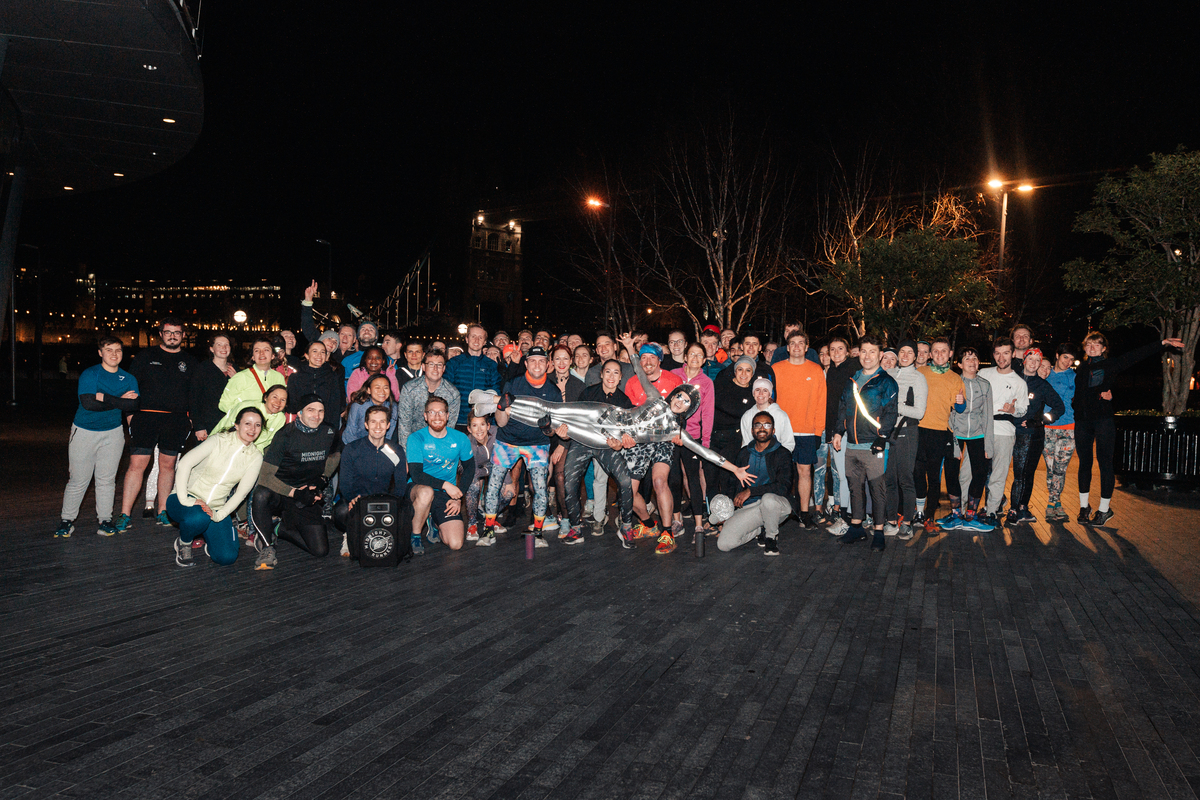 freya, the human disco ball, being lifted up by the group of 80 runners that joined her blue monday fundraising run