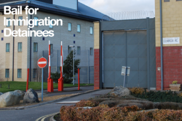 entrance of colnbrooke detention center with 'bail for immigration detainees' in white text on the top left hand corner