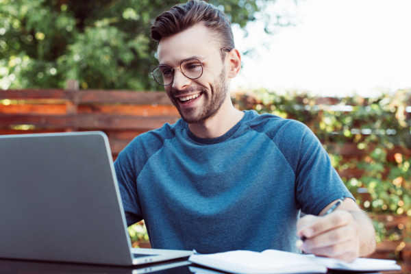 Smiling man looking at laptop