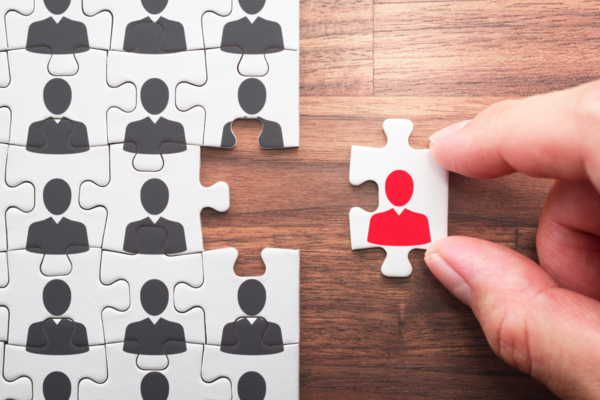 Cranfield Trust puzzle with people,one person missing from the puzzle