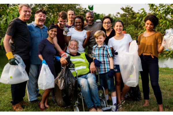 Diverse group of people standing together volunteer litter pick