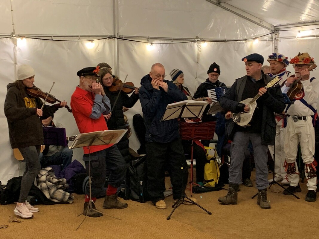 Roy Green and Jim Davies Playing Harmonica alongside other musicians at the Wassail