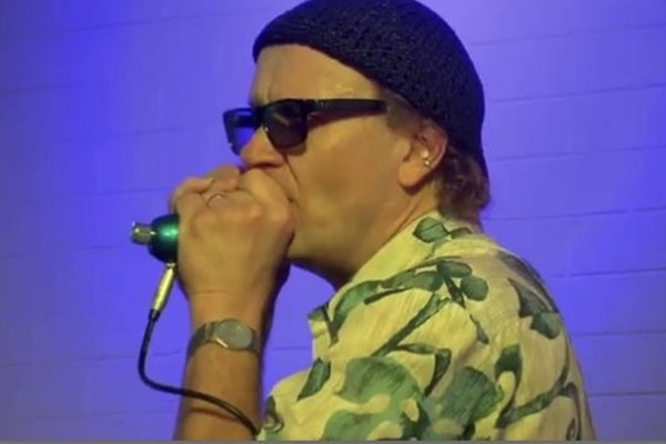Photo of Joe filisko playing harmonica