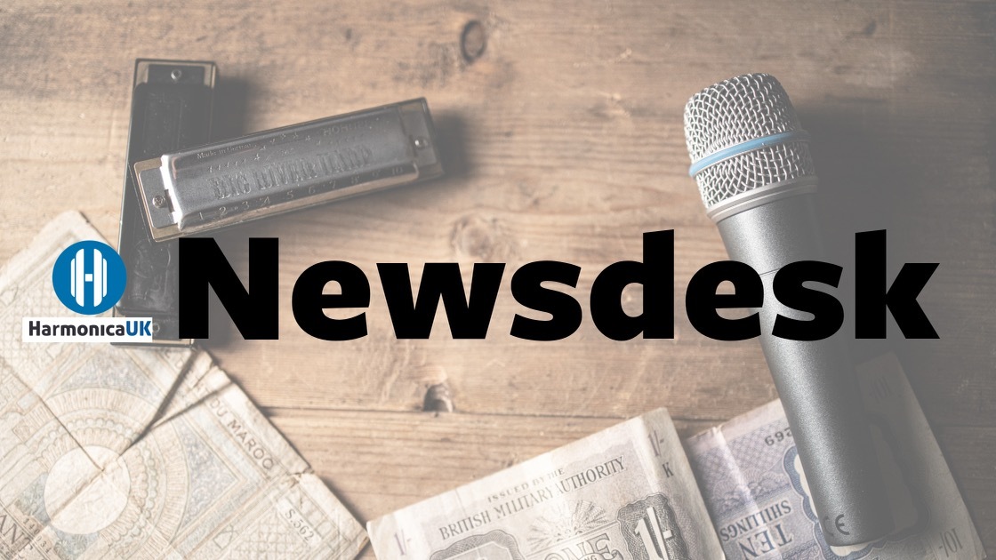 Newsdesk Header - A harmonica and a microphone on a desk