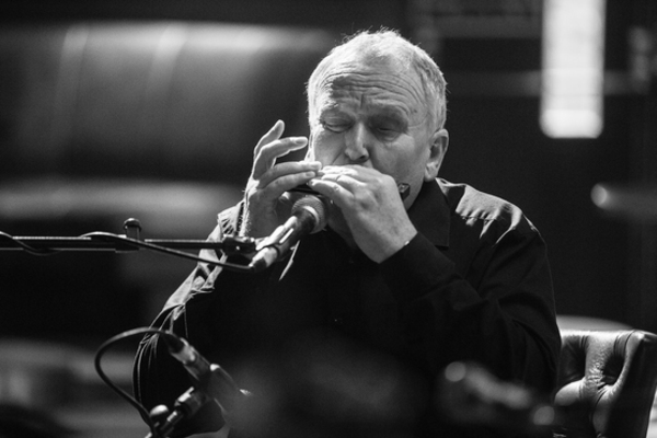 Mick Kinsella playing harmonica