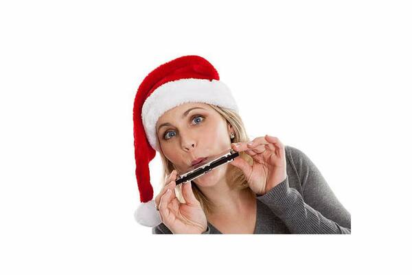 Woman in santa hat playing harmonica