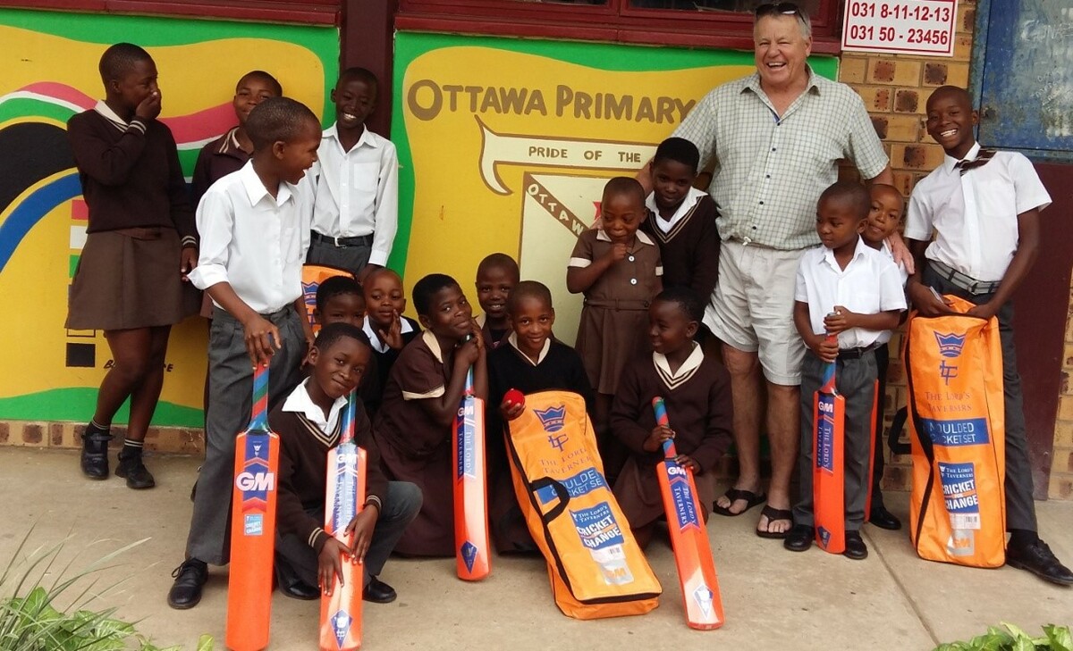 Mike Procter with the children and cricket kit supplied by the Mike Procter Foundation