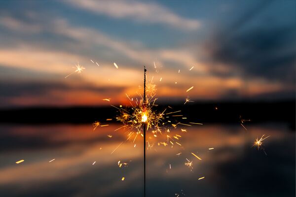 Sparkler with a sunset in the background